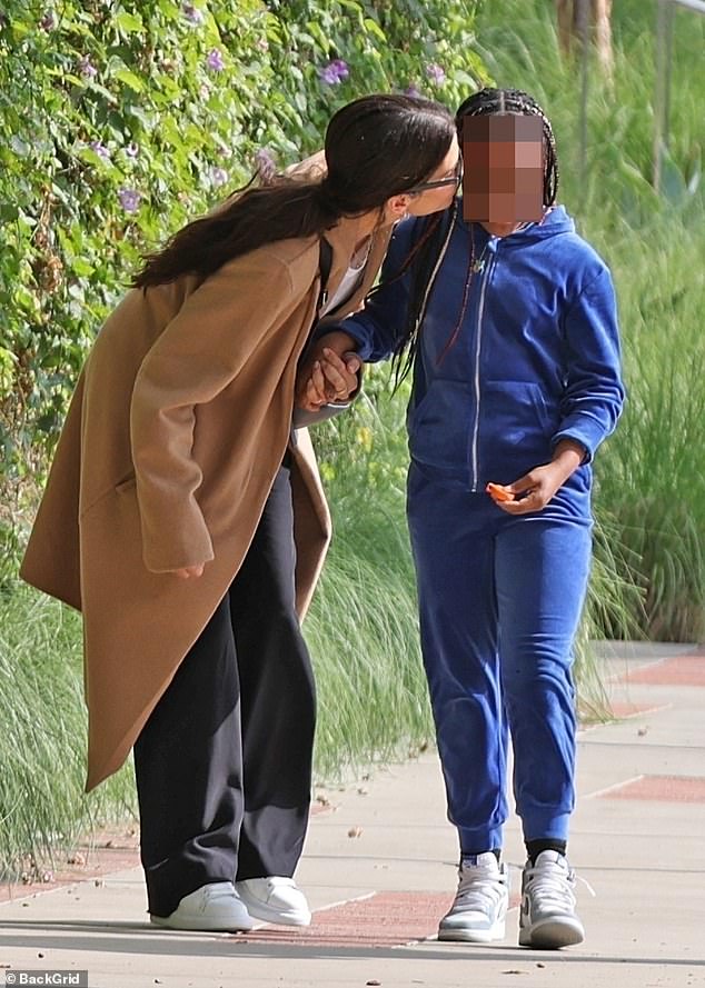 Sweet moment: Sandra planted a kiss on Laila's head during their walk